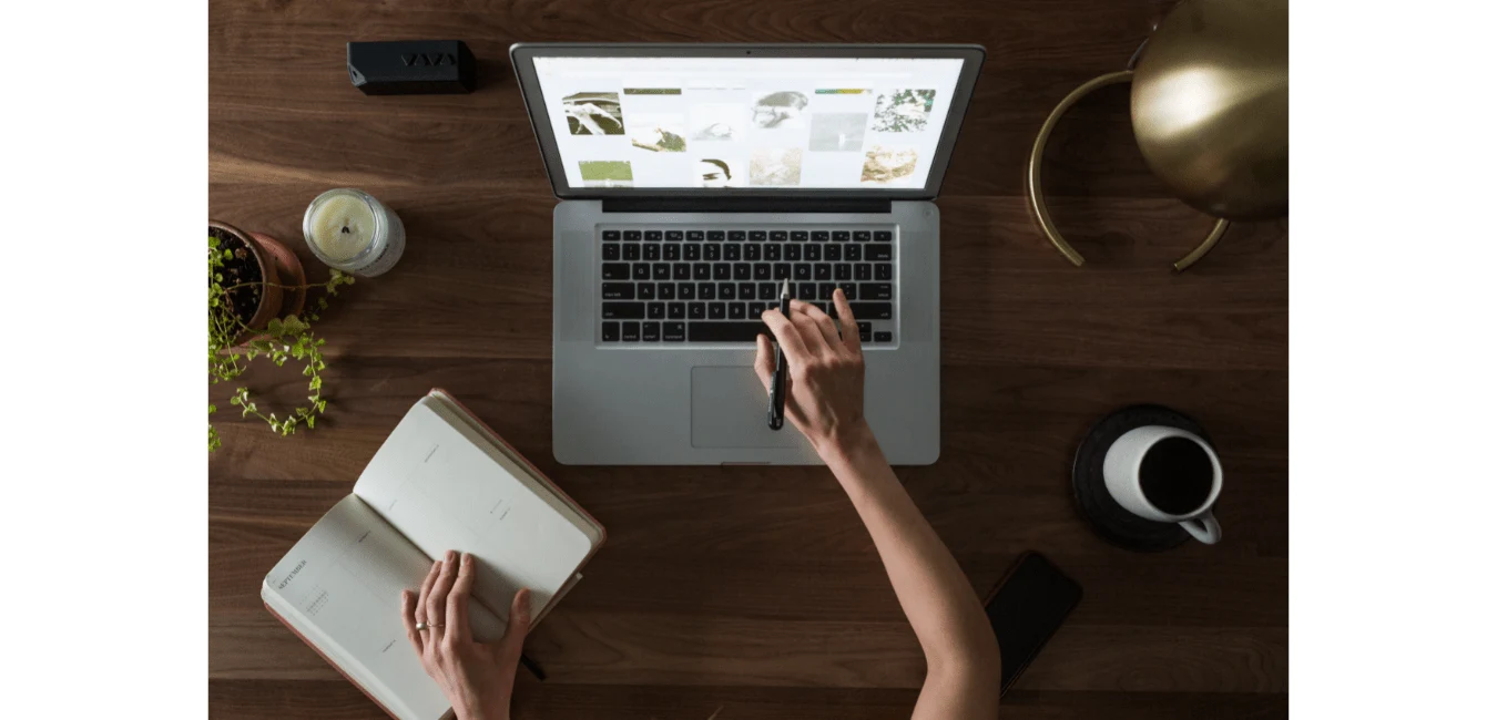person working on laptop desk