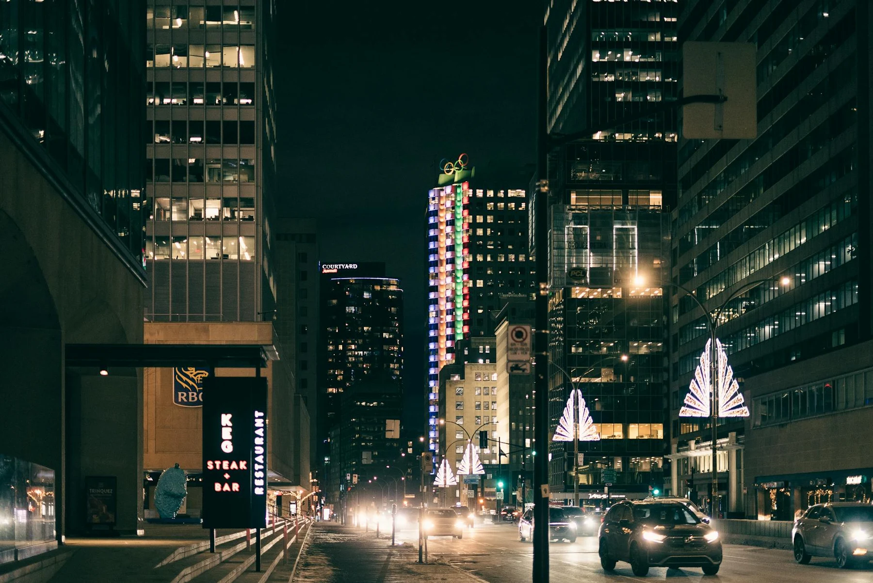 Urban night scene capturing skyscrapers and streetlights in a bustling city.