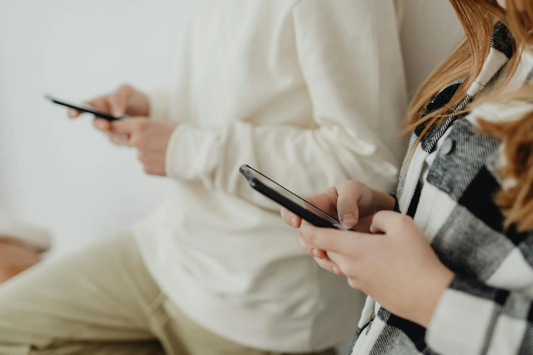 People using smartphones while comparing mobile app development companies in Vancouver